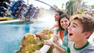 Family Watching SeaWorld Orlando Manta Roller Coaster Go By in Orlando, Florida, USA